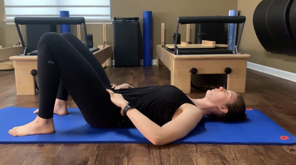 female on her back doing abdominal exercises